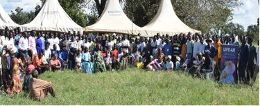 Community members in a group photo after a community awareness session